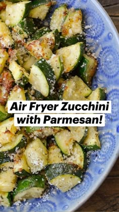 a blue and white bowl filled with cooked zucchini