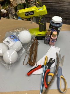 some crafting supplies are sitting on a table next to a pair of scissors and glue