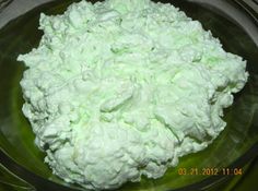 a bowl filled with whipped cream sitting on top of a table