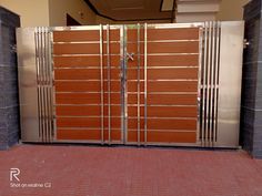 a large metal gate with wooden panels and bars