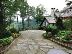 a stone path leading to a house in the woods