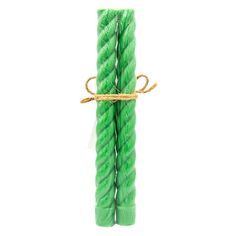 two green candles tied with twine on white background