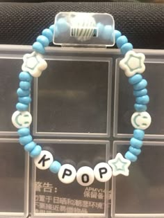 a blue and white beaded bracelet with the word pop written in chinese on it