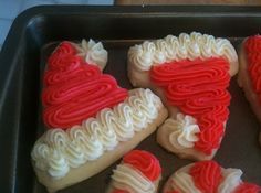 red and white decorated cookies sitting on top of a pan