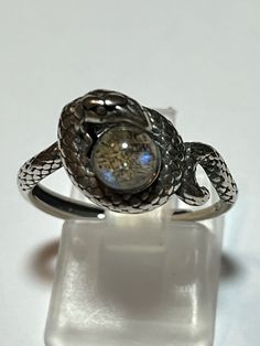 925 Sterling Silver Natural Rainbow Labradorite Snake Ring. This stone has a beautiful blue hue to it. The snake is coiled around the labradorite. The stone is 6mm in size. This ring is unique and cool. No worries about the size because this ring is an adjustable band. I’ve come to love these adjustable rings! Don’t miss out because this is the only one I have. Check out my other sterling silver pieces. We offer discounted combined shipping. Toy Trunk, Ring Pop, Snake Ring, Ring Pictures, Natural Rainbow, The Snake, Silver Pieces, Blue Hues, Adjustable Rings