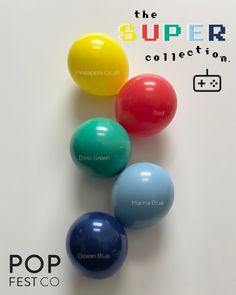 four different colored balls on a white surface with the words pop festio below them