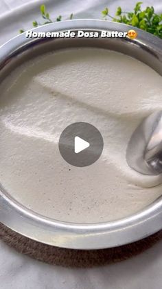 a video showing how to make homemade dosa batter in a bowl with a spoon