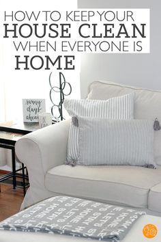 a living room with a white couch and pillows