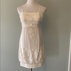 a white dress on a mannequin stand