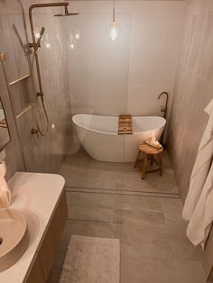 a bathroom with a bathtub, sink and mirror