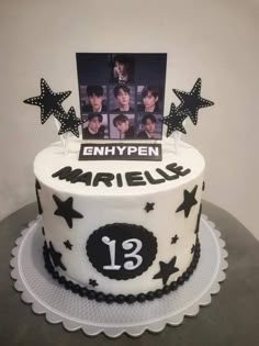 a white cake with black stars and photos on top