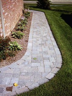 a brick walkway in front of a house