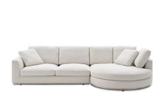 a white couch with pillows on it and a round ottoman in the middle, against a white background