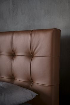 a brown leather headboard in a dark room