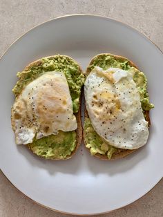 an egg and avocado toast on a white plate