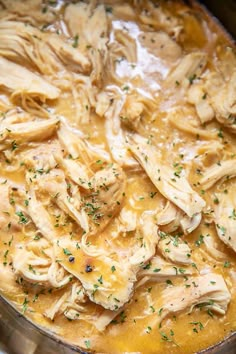 a pot filled with chicken and sauce on top of a stove