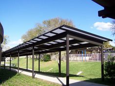 an empty covered area in the middle of a park