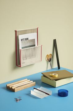 an office desk with scissors, pencils, and other items on the blue table