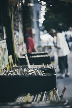 black and white photograph of record players on the street