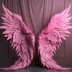 two pink angel wings sitting next to each other