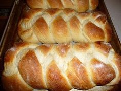 two loaves of bread sitting on top of a pan