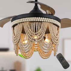 a ceiling fan with beads hanging from it's blades