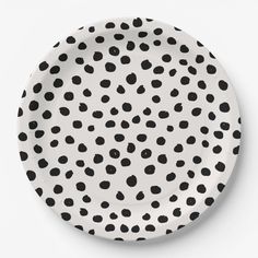 a white plate with black dots on it