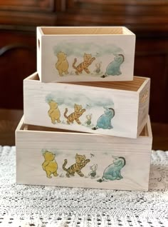 three wooden boxes with winnie the pooh pictures on them