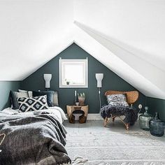 an attic bedroom with green walls and white ceiling