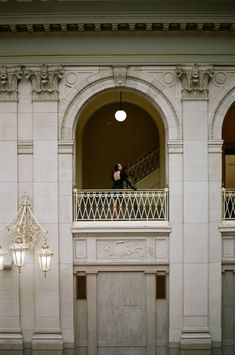 a man standing on the balcony of a building