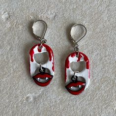 May 26 is World Dracula Day! Celebrate in style with these vampire-inspired pop tab earrings and optional matching bracelet! These lightweight white earrings are accented with red "blood" dripping down the pop tabs, and features charms with spooky vampire teeth. Perfect for your Dracula Halloween costume!  You can see the matching bracelet here: https://www.etsy.com/listing/952958724/vampire-soda-pop-tab-bracelet?ref=shop_home_active_1  All items are handmade by me in my smoke free, pet friendly home, and available to ship via USPS first class mail. Spooky Red Halloween Jewelry, Red Pierced Halloween Earrings, Red Pierced Earrings For Halloween, Red Halloween Earrings, Dracula Halloween Costume, Tab Jewelry, Tab Earrings, Pop Tab Bracelet, Soda Tab Crafts