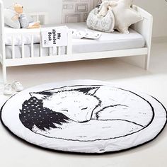 a black and white drawing of a sleeping fox on a round rug in a child's bedroom