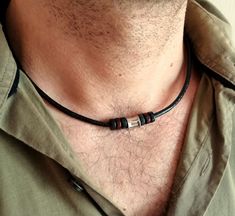 A stylish choker necklace for men is a stainless steel bead and black brown wooden beads on a genuine black leather cord with stainless steel lobster clasp closure.  This concise choker for every day will be a great gift for him. Stainless steel bead: 10 x 8 mm wooden beads: 8 x 2 mm Leather cord thickness: 3 mm For all products are used only genuine high-quality Italian leather, natural stones and wood. All metal materials are lead and nickel free.  /Gift wrapping and packaging/ :   All items ordered will be placed in a gift bag and shipped in a bubble mailer. /Jewelry care instructions/: Not recommended bathing, physical activity, swimming, sleeping while wearing jewelry. It may damage all the components of the product. Men Choker, Mens Leather Necklace, Surfer Jewelry, Cord Choker, Beads Choker, Wooden Bead Necklaces, Necklace Everyday, Necklace Bead, Leather Corded Necklace