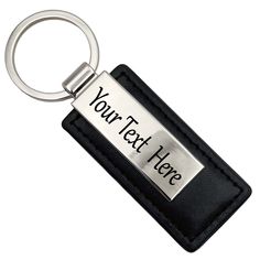 a black leather keychain with a silver metal name tag on it's side