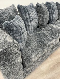 a couch with several pillows on top of it