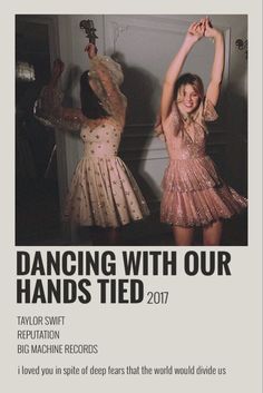 two women in dresses are dancing with their hands up