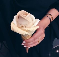 a woman holding a white flower in her hands