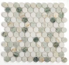 a white and green mosaic tile with circles on the back ground, in various sizes