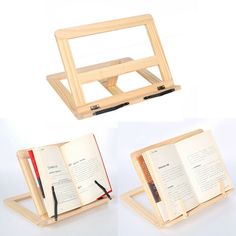 an open book sitting on top of a wooden stand next to a pen and notebook