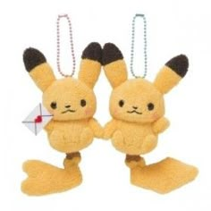 two yellow stuffed animals hanging from strings on a white background and one has an ornament in the shape of a pikachu