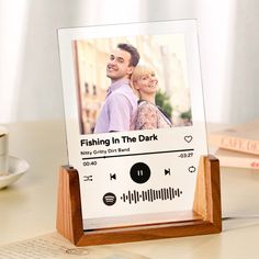 a wooden frame with a photo of a man and woman in the background on top of a table