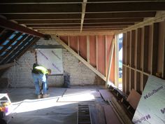 a man standing in the middle of a room under construction