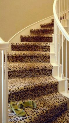 a pair of slippers sitting on the bottom of a set of leopard print stairs