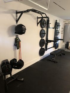 an empty gym room with equipment hanging on the wall