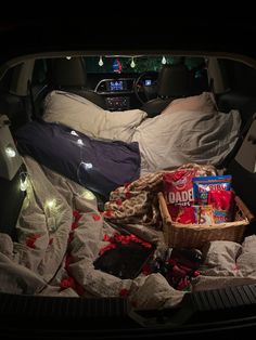 the trunk of a car with food and snacks in it, all packed up for christmas