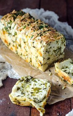 a loaf of bread with cheese and herbs on it