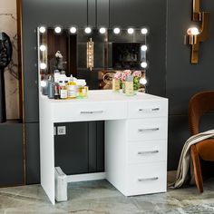 a white vanity with lights on it next to a chair