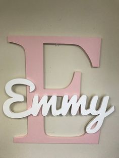 a wooden sign that says,'i ammy'in white letters on a pink background