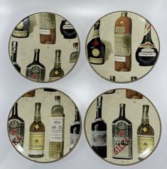 four plates that have different types of liquor on them, each one has an individual's own bottle