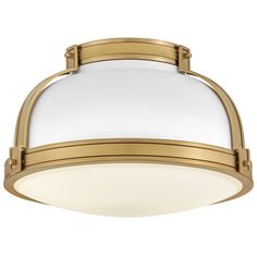 a flush light fixture with an oval glass shade on the bottom and gold trimming